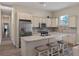 Bright kitchen with stainless steel appliances, center island, and tile backsplash at 20199 Sweetwood Ln, Clermont, FL 34715