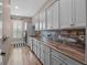Bright laundry room featuring a window, wooden floors, generous counter space, and updated appliances at 20199 Sweetwood Ln, Clermont, FL 34715