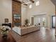 Elegant living room featuring a stone fireplace and an open layout for entertaining at 20199 Sweetwood Ln, Clermont, FL 34715