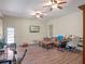 Spacious living area featuring a TV, exercise equipment, and access to the outdoors at 20199 Sweetwood Ln, Clermont, FL 34715