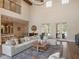 Spacious living room with high ceilings, lots of natural light, and an open floor plan at 20199 Sweetwood Ln, Clermont, FL 34715