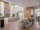 Open concept living area features a stone fireplace, large windows, and a modern kitchen at 20199 Sweetwood Ln, Clermont, FL 34715