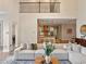 Bright living room showcases a large sectional sofa and flows seamlessly into the kitchen at 20199 Sweetwood Ln, Clermont, FL 34715