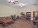 Open living area with a sofa, desk, exercise equipment, and hardwood floors at 20199 Sweetwood Ln, Clermont, FL 34715