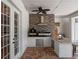 Outdoor kitchen with high-end appliances, stone backsplash, granite countertops, and modern fixtures at 20199 Sweetwood Ln, Clermont, FL 34715