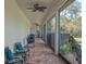 Covered patio with outdoor seating, screened windows, and a view of the backyard at 20199 Sweetwood Ln, Clermont, FL 34715