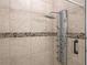 Tiled shower featuring a multi-jet system and decorative stone accents for a spa-like experience at 20199 Sweetwood Ln, Clermont, FL 34715