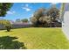 Large backyard with green grass, trees, and a fenced perimeter at 226 Selkirk Way, Longwood, FL 32779