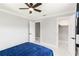 A bright bedroom featuring a ceiling fan, white trim, and doorways to a closet and bathroom at 226 Selkirk Way, Longwood, FL 32779