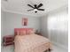 A cozy bedroom featuring a ceiling fan, a window with sheer curtains, and pink decor at 226 Selkirk Way, Longwood, FL 32779