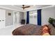 Comfortable bedroom featuring a decorative bed, blue curtains and large windows at 226 Selkirk Way, Longwood, FL 32779