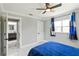 A bright bedroom featuring a ceiling fan, white trim, and doorway to a bathroom at 226 Selkirk Way, Longwood, FL 32779