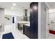 Stylish kitchen showcasing dark blue cabinets, stainless hood, and white marble countertops at 226 Selkirk Way, Longwood, FL 32779