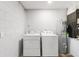 Functional laundry room with white washer and dryer, and a water heater at 226 Selkirk Way, Longwood, FL 32779