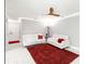 Cozy living room with red rug, white sofas, and bright white flooring at 226 Selkirk Way, Longwood, FL 32779