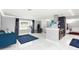 Spacious living room with blue couch, adjacent to kitchen with white marble floors throughout at 226 Selkirk Way, Longwood, FL 32779