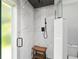 A tiled walk-in shower features a rainfall shower head, a wooden shower bench, and glass door at 226 Selkirk Way, Longwood, FL 32779
