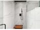 A tiled walk-in shower features a rainfall shower head and a wooden shower bench at 226 Selkirk Way, Longwood, FL 32779