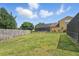 The fenced-in backyard has lush green grass and a screened-in patio with a pool and seating at 231 Chestnut Creek Dr, Apopka, FL 32703