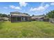 The fenced-in backyard has lush green grass and a screened-in patio with a pool at 231 Chestnut Creek Dr, Apopka, FL 32703