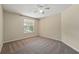Inviting bedroom features neutral carpet, a ceiling fan, and a window for ample natural light at 231 Chestnut Creek Dr, Apopka, FL 32703