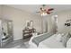 Cozy bedroom featuring a large window, ceiling fan, and wood-look floors at 231 Chestnut Creek Dr, Apopka, FL 32703
