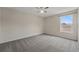 Spacious bedroom with neutral carpet, a ceiling fan, and a window providing natural light at 231 Chestnut Creek Dr, Apopka, FL 32703