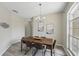Elegant dining room with a modern chandelier and a large window at 231 Chestnut Creek Dr, Apopka, FL 32703