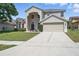 Beautiful two-story home with a spacious driveway and attached two-car garage at 231 Chestnut Creek Dr, Apopka, FL 32703