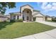 Inviting two-story home with a well-kept lawn and classic architectural details at 231 Chestnut Creek Dr, Apopka, FL 32703