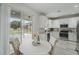 Bright eat-in kitchen with modern white cabinets, stainless appliances, granite counters, and backyard access at 231 Chestnut Creek Dr, Apopka, FL 32703