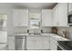 Updated kitchen featuring granite countertops, stainless steel appliances, and white cabinets at 231 Chestnut Creek Dr, Apopka, FL 32703