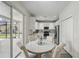 Eat-in kitchen featuring white cabinets, stainless appliances, a sliding glass door, and backyard views at 231 Chestnut Creek Dr, Apopka, FL 32703