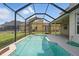 An inviting screened-in pool is surrounded by lush green grass and sits adjacent to the home's patio at 231 Chestnut Creek Dr, Apopka, FL 32703
