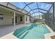 A beautiful pool sits within a screened enclosure and is adjacent to the home's covered patio at 231 Chestnut Creek Dr, Apopka, FL 32703
