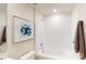 Well-lit bathroom featuring a tub and shower combo, white tiling, and contemporary fixtures at 245 Streamliner Way, Groveland, FL 34736