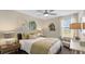 Bedroom featuring a queen bed, accent chair, art, lots of light and a ceiling fan at 7542 Headwaters Ct, Groveland, FL 34736