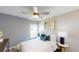 Bright bedroom with a queen-sized bed, contemporary decor, and a large window at 245 Streamliner Way, Groveland, FL 34736
