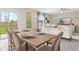 Dining area with wood table, six chairs, large sliding glass doors to a fenced yard, and an open floor plan at 7542 Headwaters Ct, Groveland, FL 34736