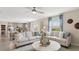 Living room with neutral furniture, an octagonal coffee table, open to the dining area and kitchen, and lots of sunlight at 7542 Headwaters Ct, Groveland, FL 34736