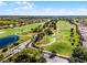 Scenic aerial view overlooking a golf course, lush greenery, homes, and a pond at 2520 Oakington St, Winter Garden, FL 34787