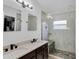Bright bathroom features double sinks, a spacious shower with stone base and modern fixtures for spa retreat at 2520 Oakington St, Winter Garden, FL 34787