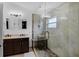Bathroom with dual vanity sinks, a large glass-enclosed shower with a tiled bench and modern fixtures at 2520 Oakington St, Winter Garden, FL 34787