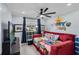 Colorful bedroom features a modern ceiling fan, a day bed, neutral paint, and fun decor at 2520 Oakington St, Winter Garden, FL 34787