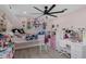 Bright bedroom boasting pink walls, modern fan, shelving, and a nice view at 2520 Oakington St, Winter Garden, FL 34787