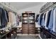 Spacious walk-in closet with custom shelving, shoe racks, and storage for all of your fashion needs at 2520 Oakington St, Winter Garden, FL 34787