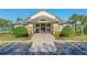 Clubhouse entrance with manicured landscaping, palm trees, and accessible parking at 2520 Oakington St, Winter Garden, FL 34787
