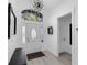 Welcoming entryway features a decorative front door, a modern light fixture, and light colored flooring at 2520 Oakington St, Winter Garden, FL 34787