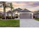Charming home featuring a well-manicured lawn, tropical landscaping and a two-car garage at 2520 Oakington St, Winter Garden, FL 34787