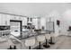 Bright kitchen with large granite island, seating, stainless appliances, and white cabinetry for a sleek, modern design at 2520 Oakington St, Winter Garden, FL 34787